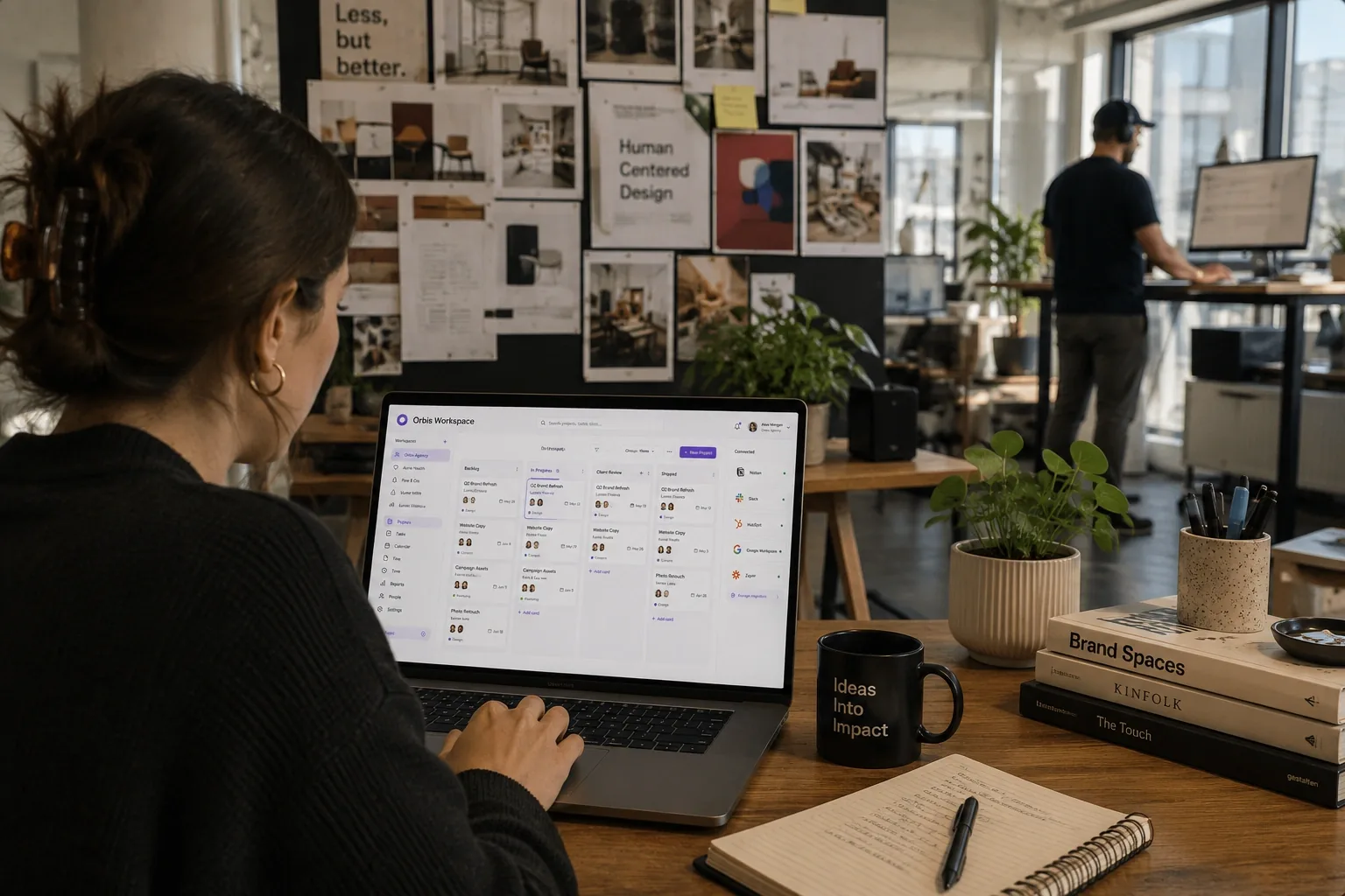 Designer working in the Orbis workspace at a creative agency